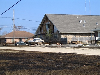 Damaged warehouse and cars