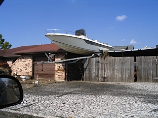boat sitting completely on top of house