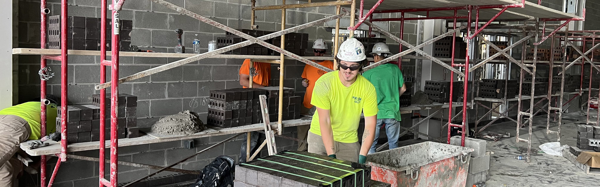 Four workers standing around looking at a crack in the ground.