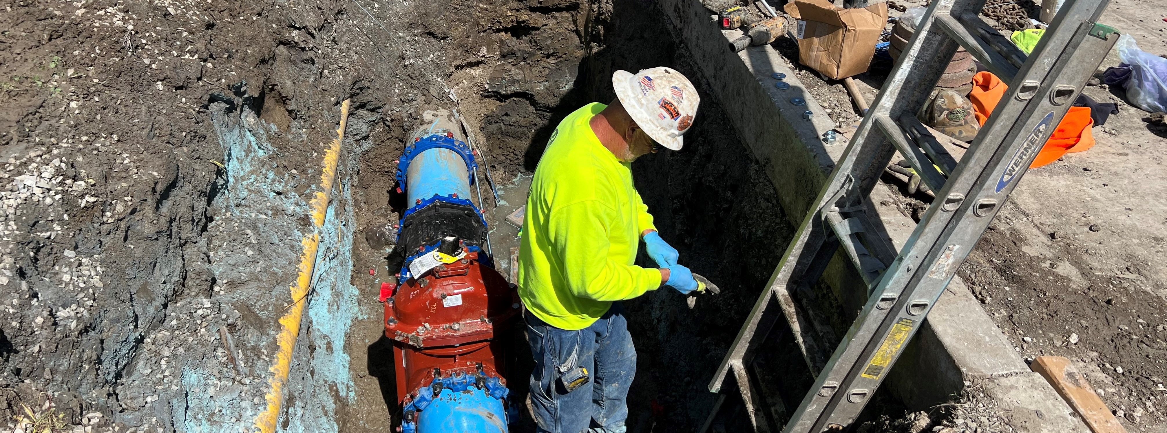 Man standing in a hole in a construction site